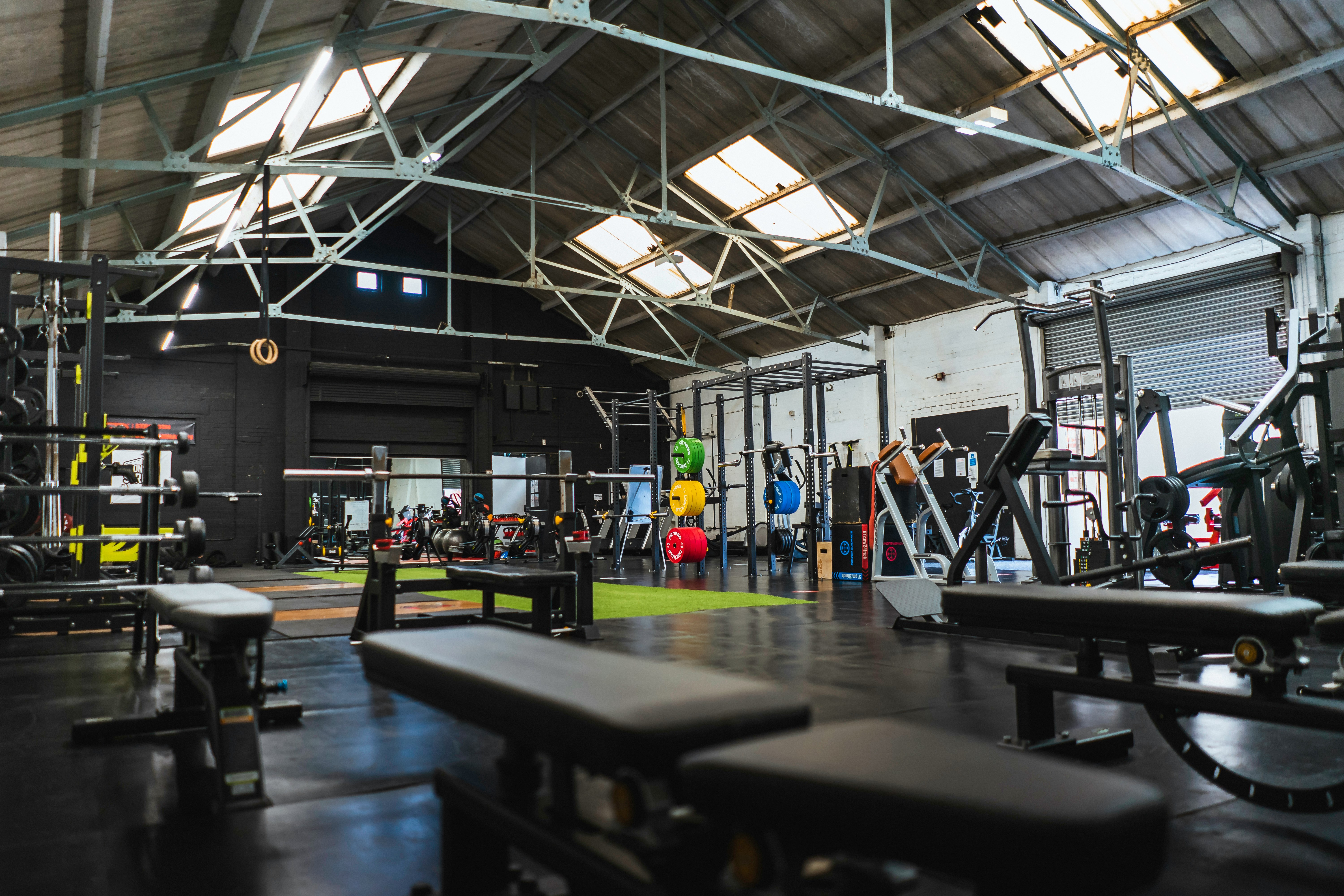 Athlete training with barbell in gritty gym environment